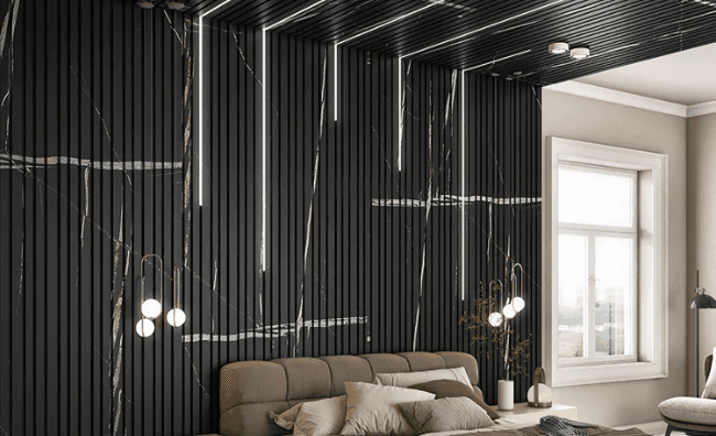Black fluted louver panel wall with pendant lighting behind a bedroom headboard